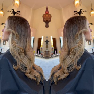 A reflection of a woman 's hair in a mirror