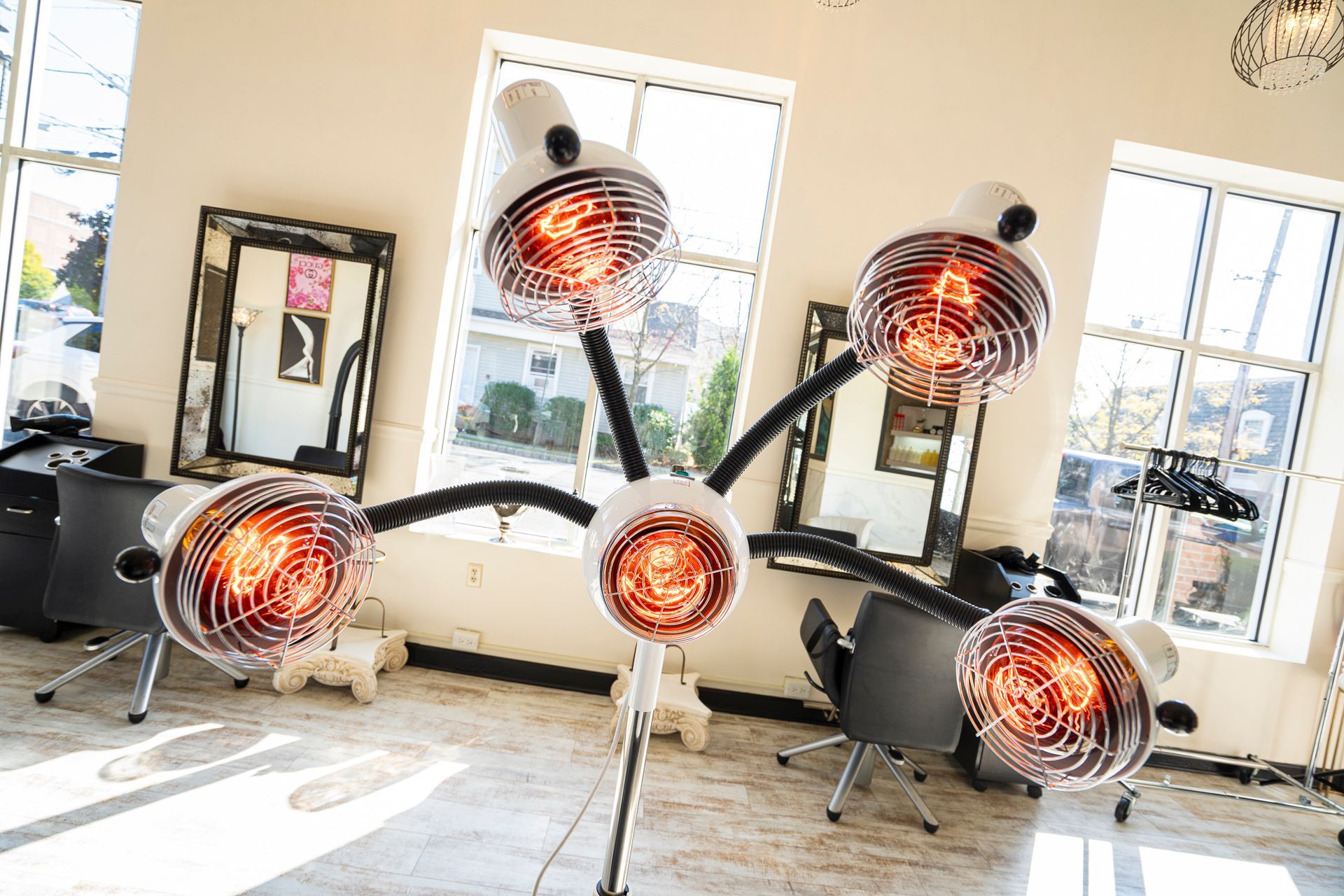 A hair salon with a bunch of hair dryers and mirrors.