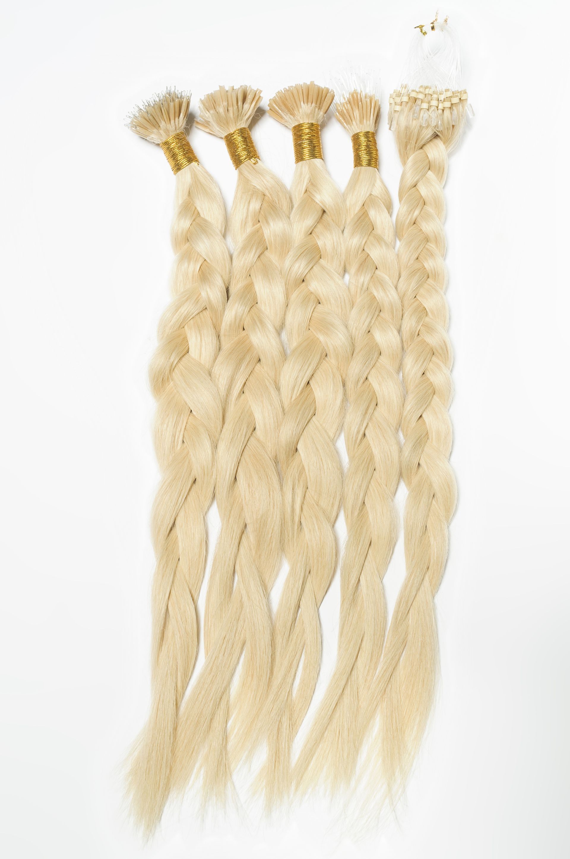 A bunch of blonde hair extensions on a white background.