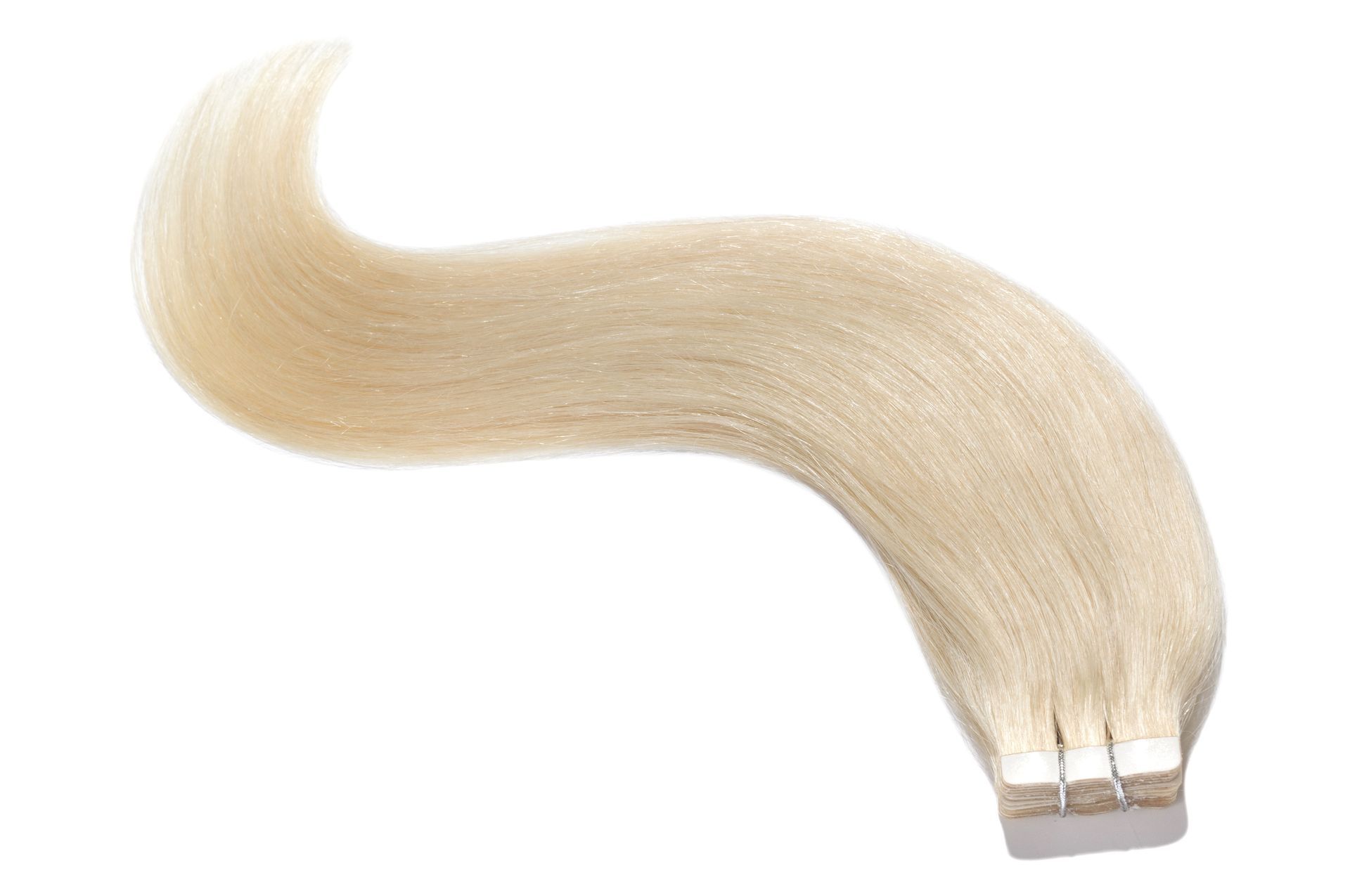 A piece of blonde hair extensions on a white background.