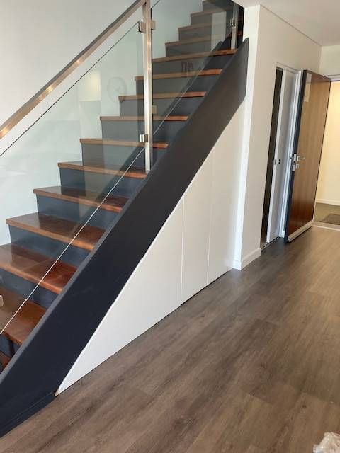 A Black and Wooden staircase — Tefa Kitchens & Joinery in Rutherford, NSW