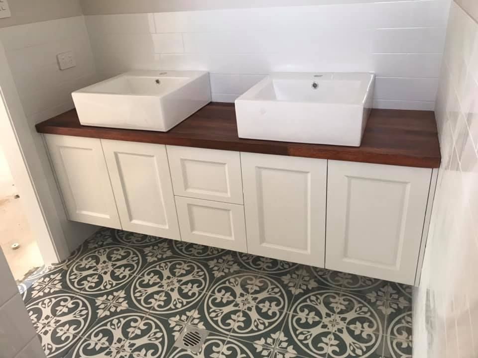 Two Sinks Are Sitting on Top of a Wooden Counter in a Bathroom — Tefa Kitchens & Joinery in Rutherford, NSW