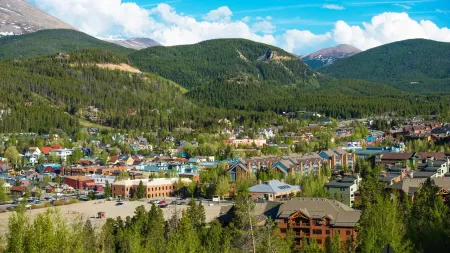 An aerial view of a small town surrounded by mountains.