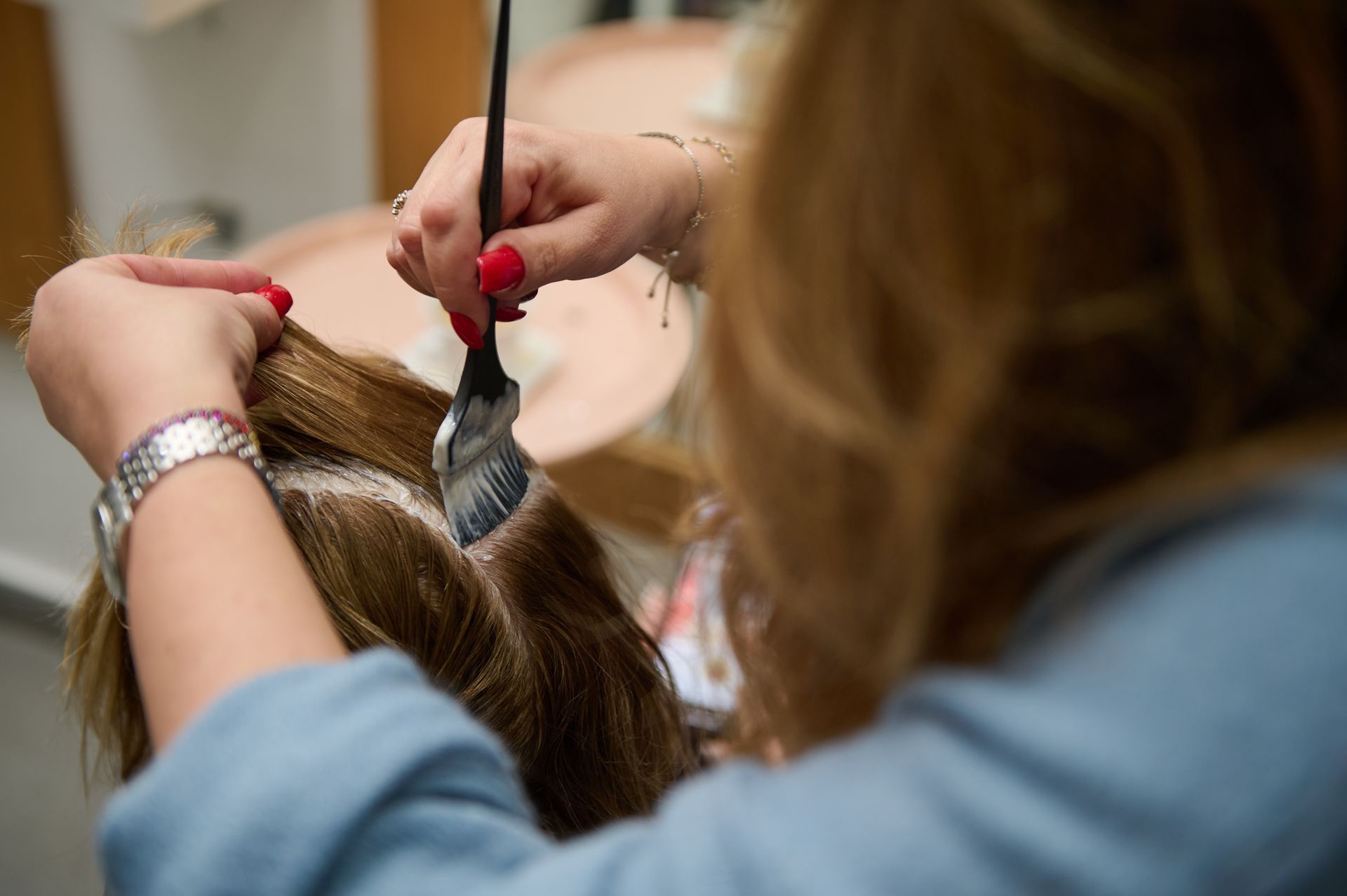 Person Applying Hair Dye With a Brush — 5th Ave Hair Lounge in Caloundra, QLD