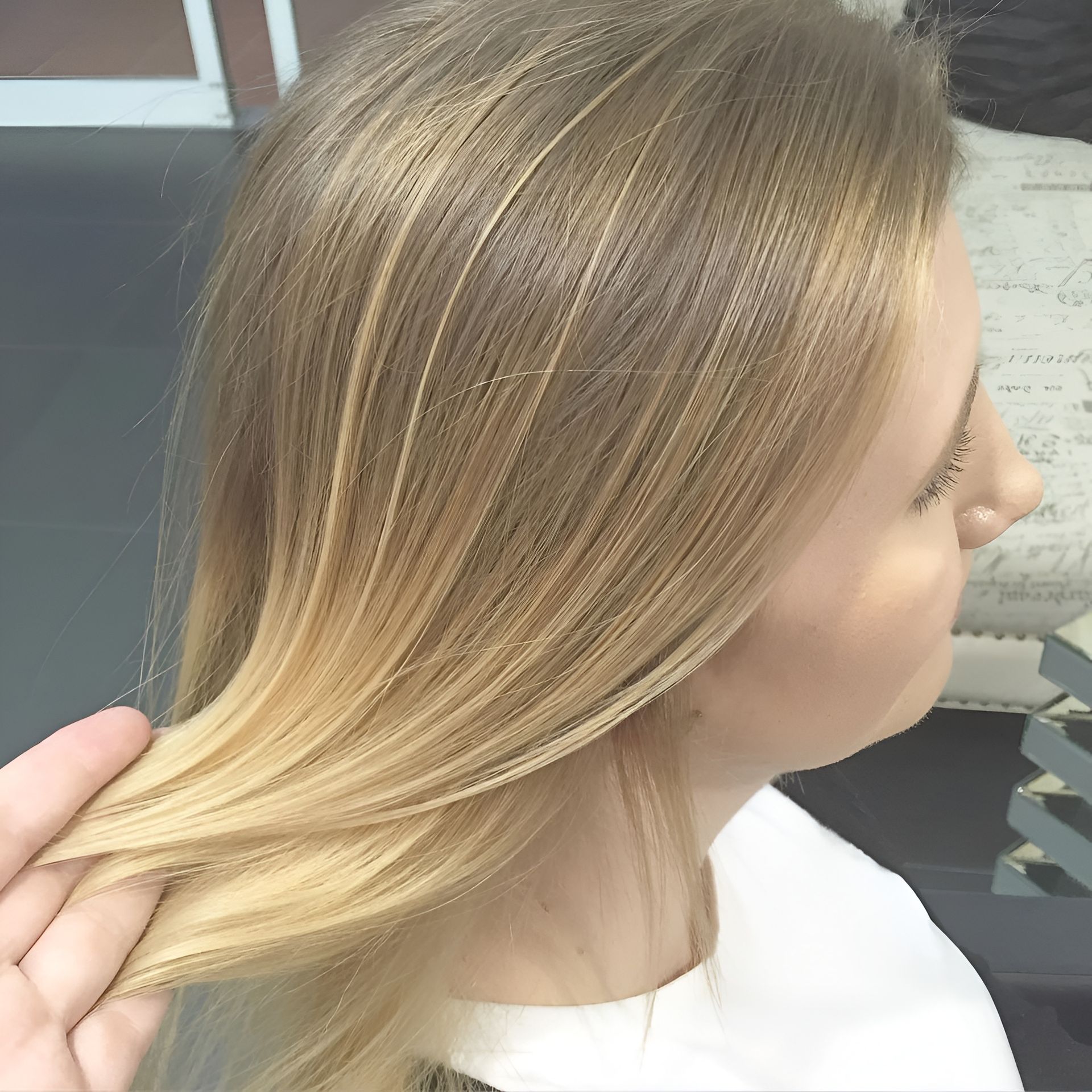 Woman With Blonde Hair, Hand Touching the Ends — 5th Ave Hair Lounge in Caloundra, QLD