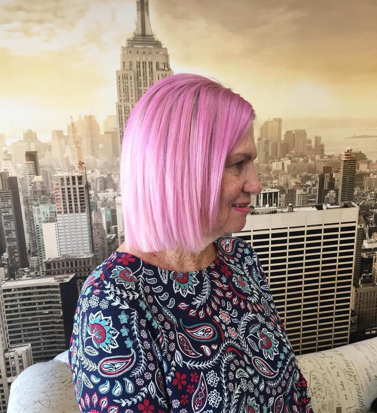 Woman With Pink Hair and a Patterned Shirt in Front of a City Backdrop — 5th Ave Hair Lounge in Caloundra, QLD