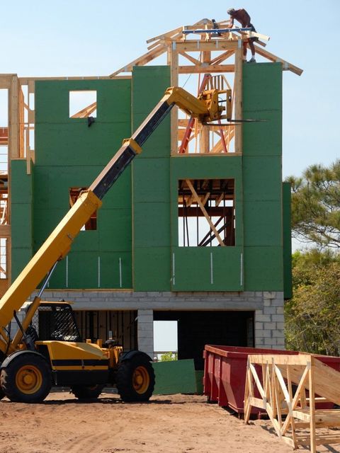 A crane is being used to build a house