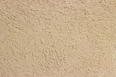 Texture de mur en stuc beige.