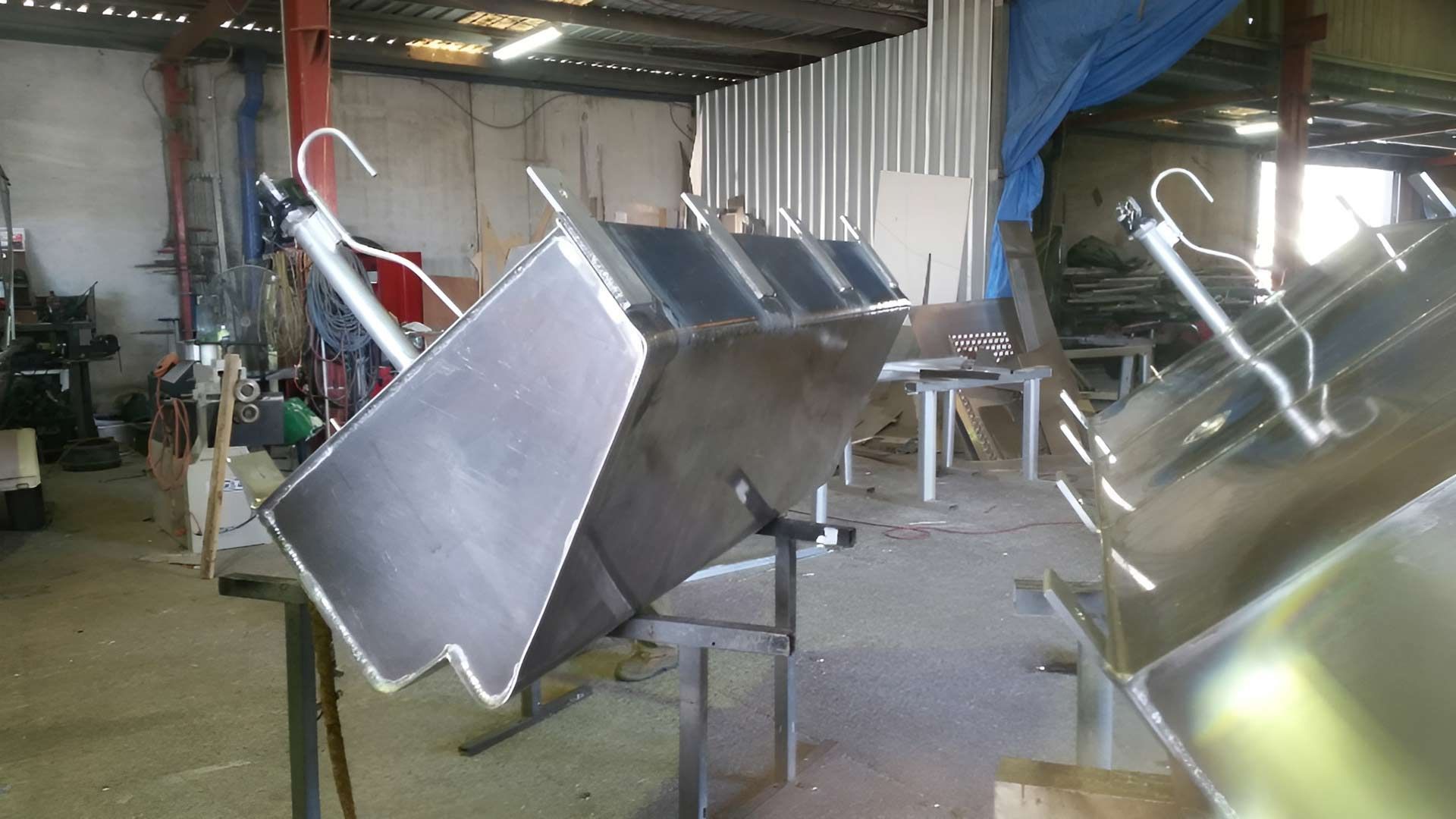 Stainless Steel Containers Are Sitting On A Table In A Welding Shop — Brumb's Welding & Fabrication in Biggera Waters, QLD
