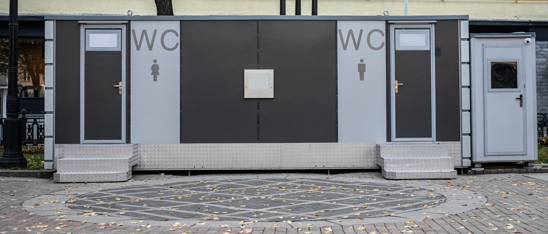 Facade of outdoor luxury portable toilets with men's and women's WC sign. Facade of outdoor luxury portable toilets with men's and women's WC sign.