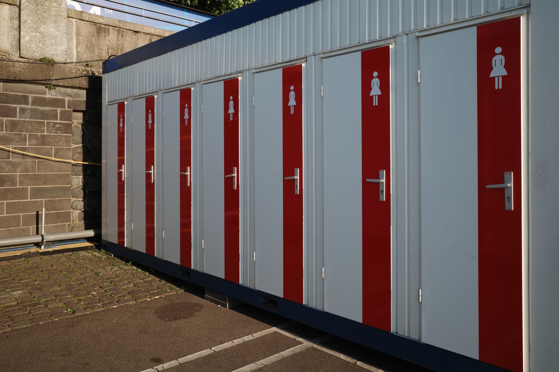 A row of portable restroom cabins.
