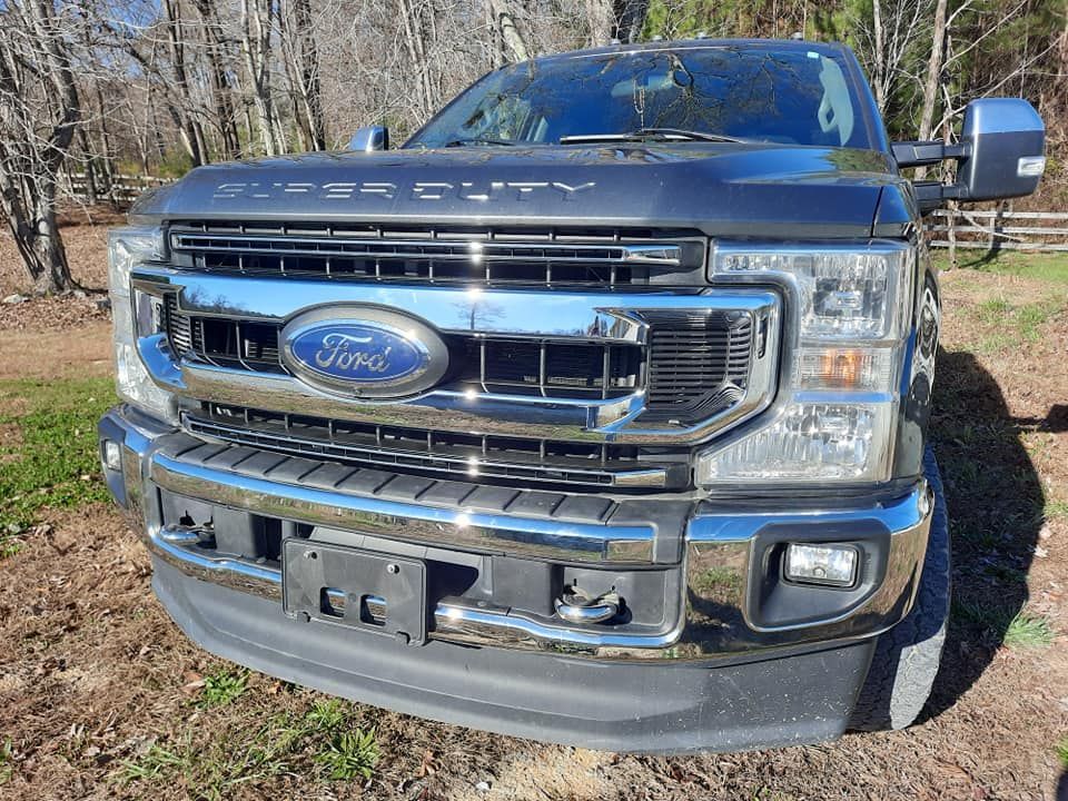 Blue Ford pickup truck front view parked outdoors with chrome grille and bumper