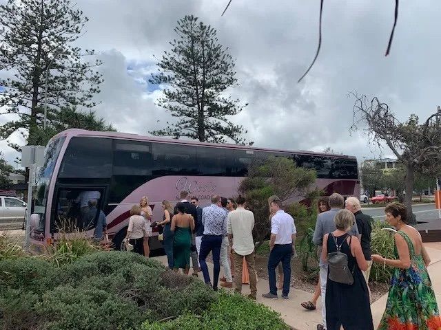 Group of people getting on a hired coach