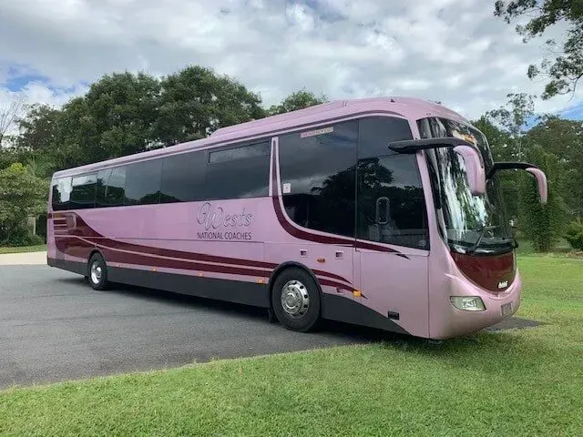 Pink Wests National Coach Bus Parked Outdoors On The Sunshine Coast