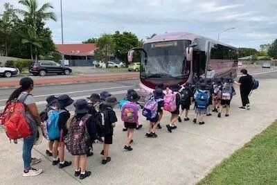 A Group of Children Are Walking Towards a Bus — Wests National Coaches In Chevallum, QLD