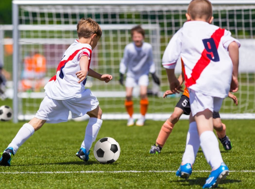 A Group of Young Boys Are Playing Soccer on a Field — Wests National Coaches In Chevallum, QLD