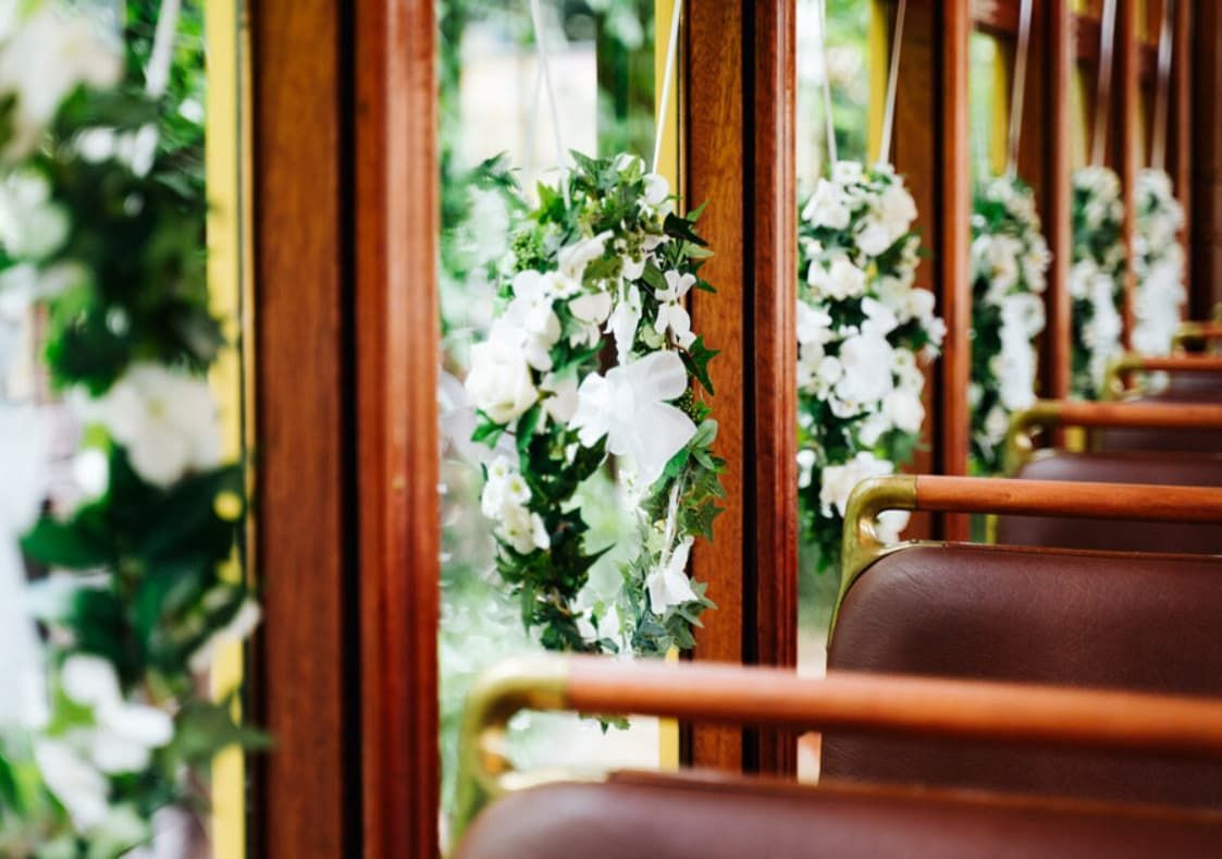 A Row of Bus Seats Decorated With White Flowers and Greenery — Wests National Coaches In Chevallum, QLD