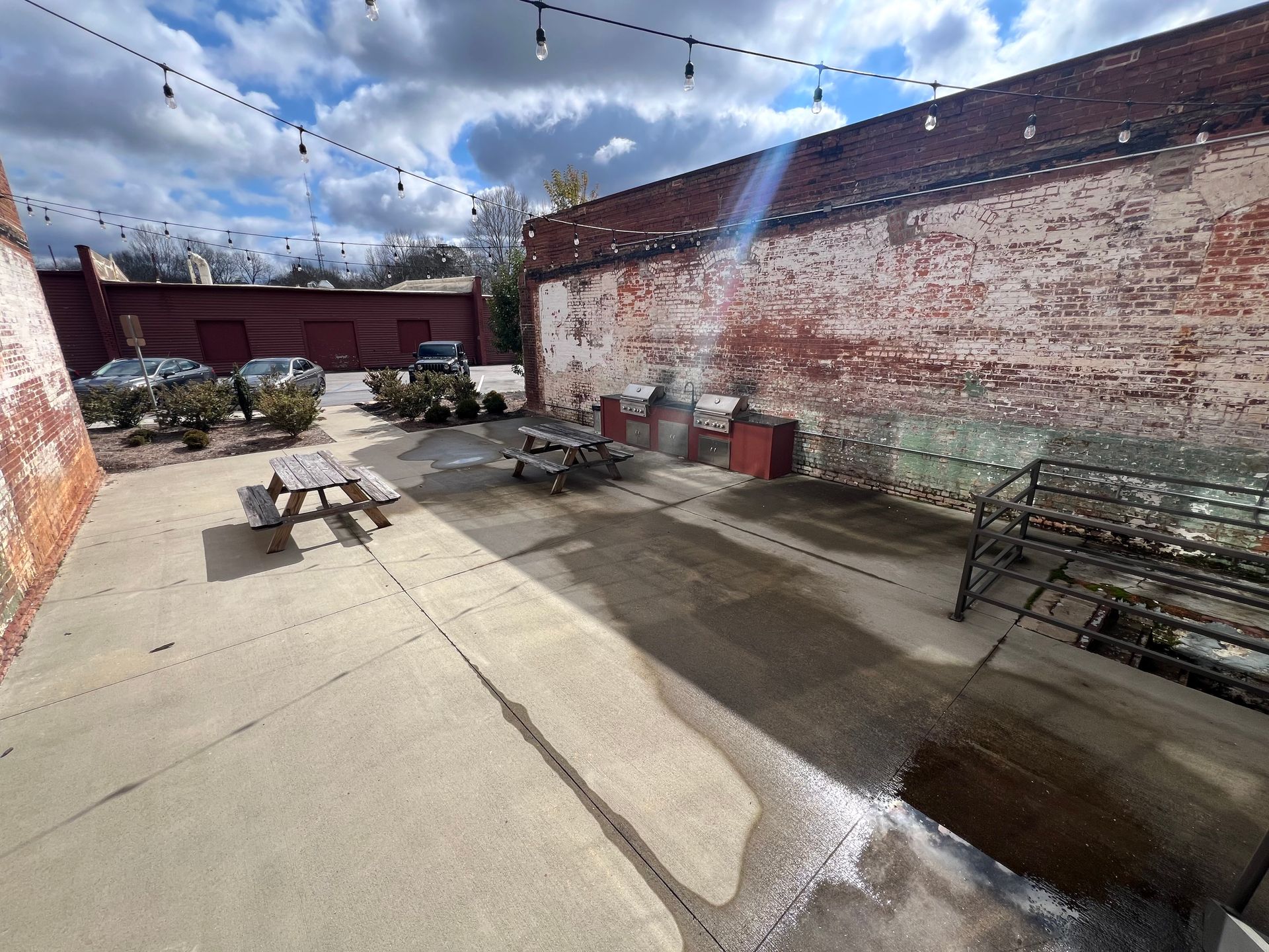 a brick wall with a picnic table in front of it