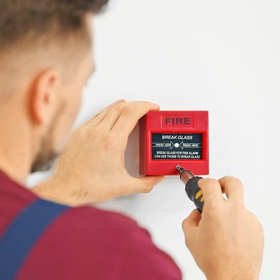 Electrician installing fire alarm system