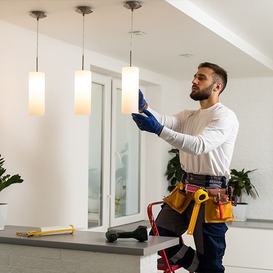 The hands of an electrician installing a power socket