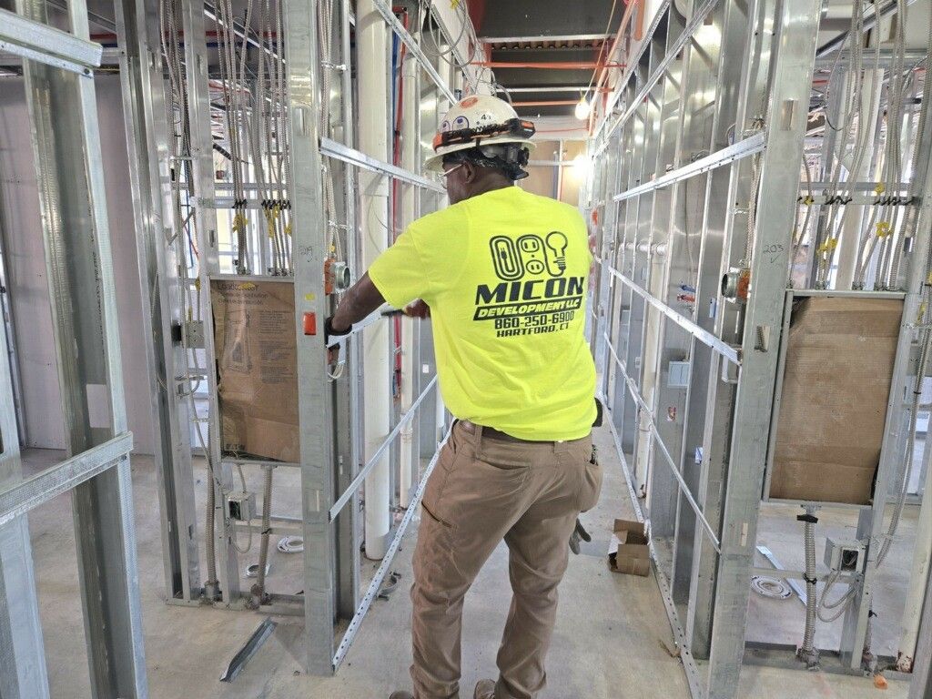 Portrait of an industrial electric engineer standing by power supply inside oil refinery