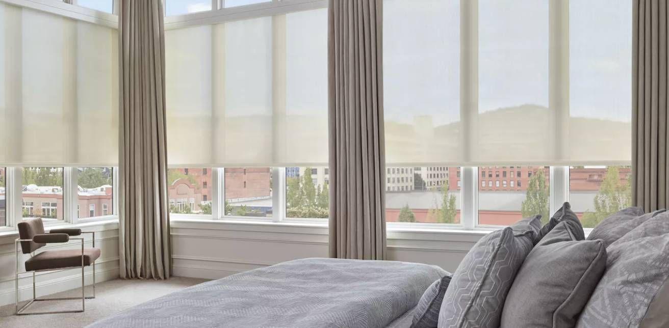 Hunter Douglas Designer Solar Shades covering bedroom windows