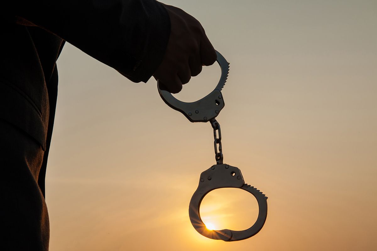 Man Holding a Handcuffs — Antonio, TX — Bail Bond Attorney San Antonio