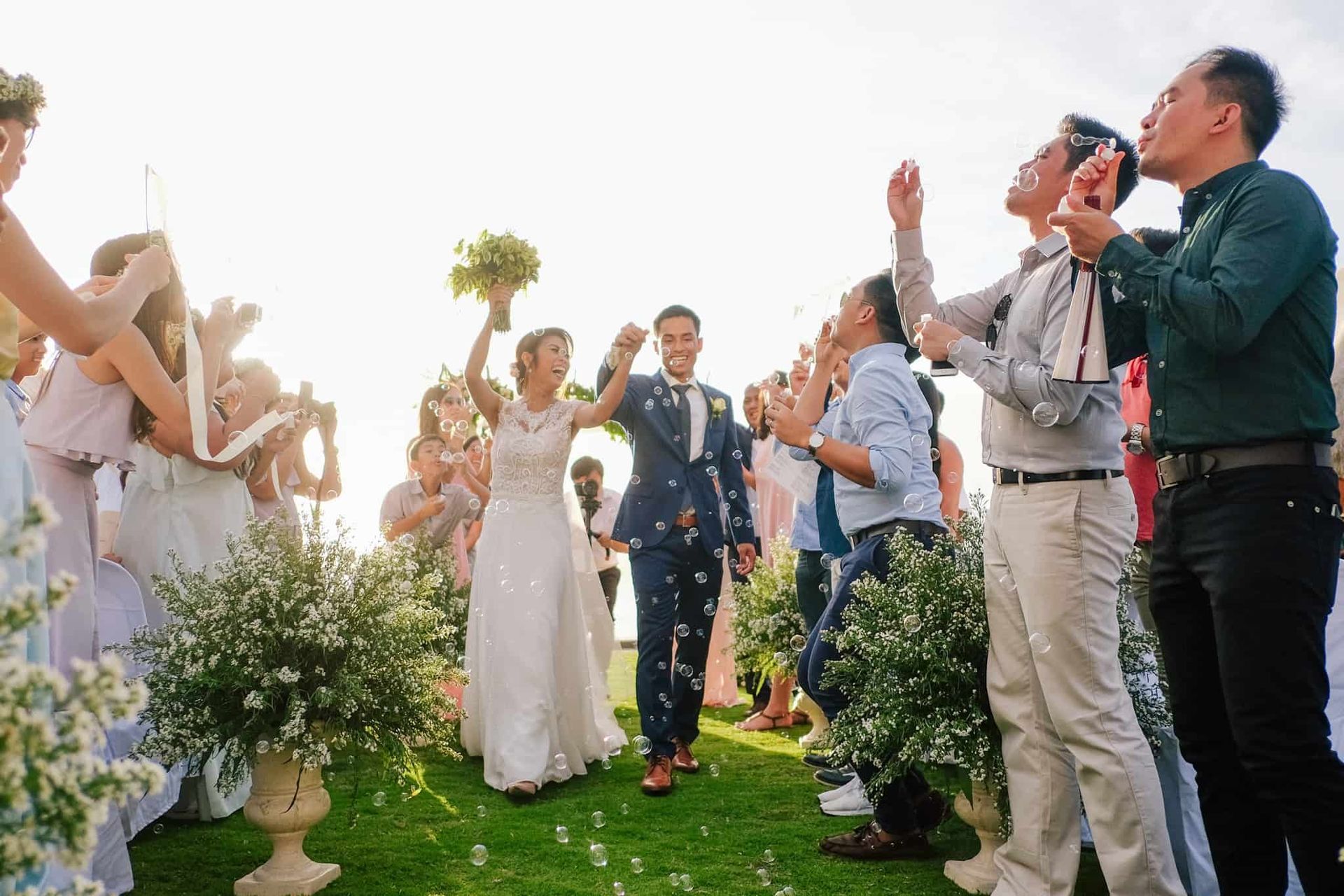 Destination wedding celebration at Pure Shores Villa with guests on the clifftop overlooking the sea in Bohol Philippines