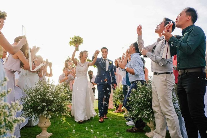Destination wedding celebration at Pure Shores Villa with guests on the clifftop overlooking the sea in Bohol Philippines