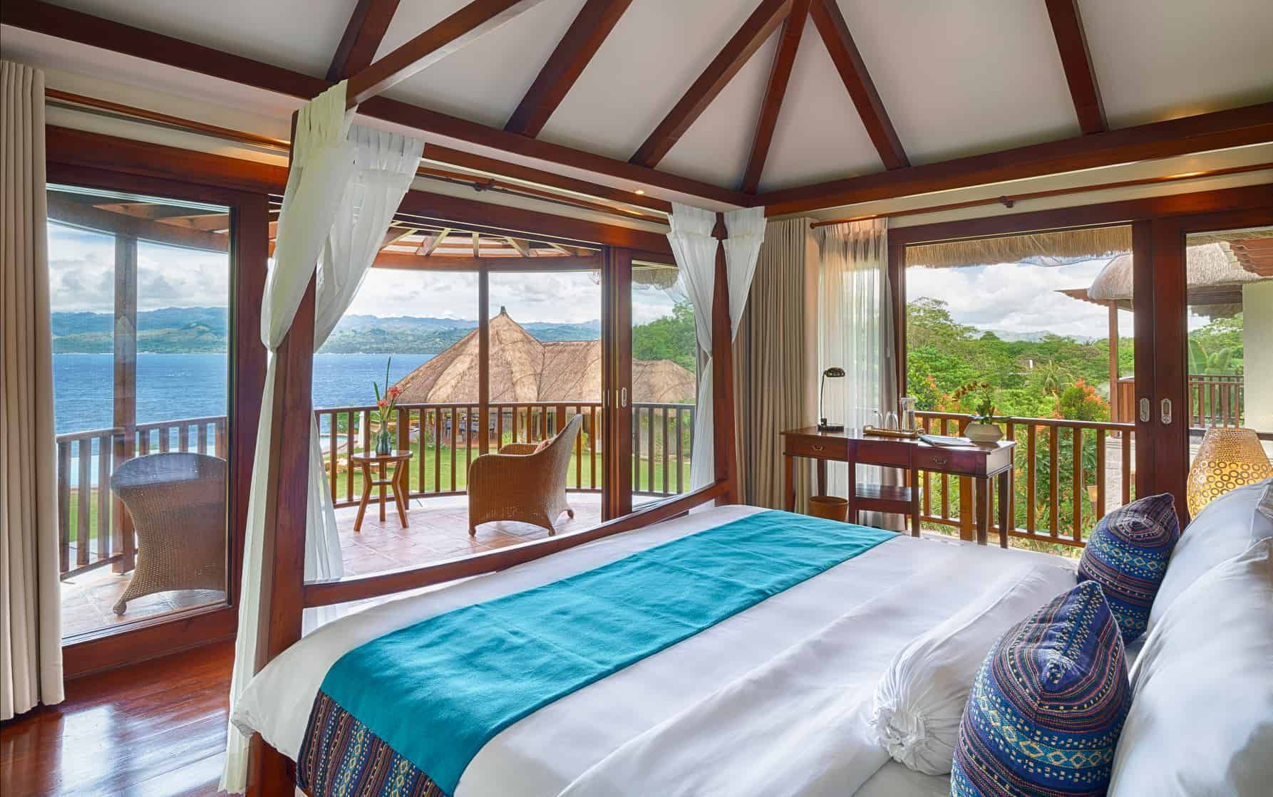 Bedroom 1 with king-sized canopy bed and tropical views at Pure Shores Villa Bohol Philippines