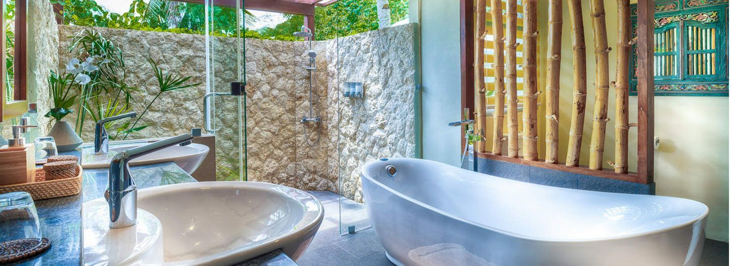 Ensuite bathroom with outdoor shower and stone bathtub in Bedroom 4 at Pure Shores Villa Bohol