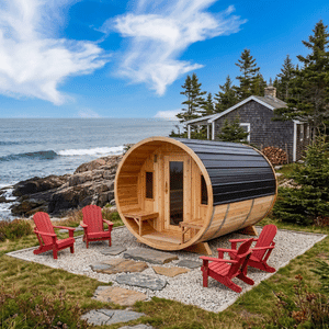 Wooden barrel sauna by the rocky shore with red chairs, ocean waves, and a coastal cabin behind it