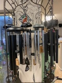Decorative metal wind chimes and hanging ornaments displayed indoors