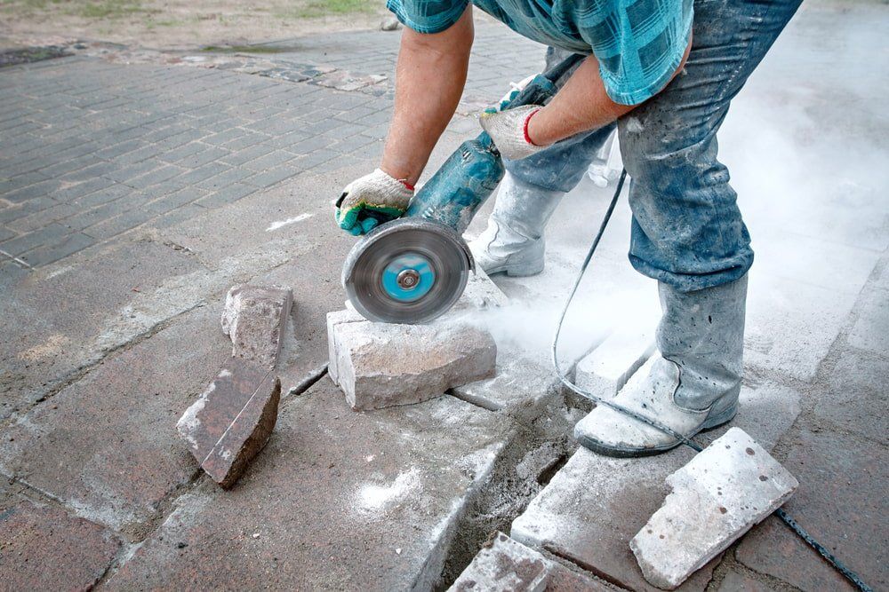 Worker Saws Stones With Circular Saw — Hand & Ring Sawing in Bundaberg, QLD