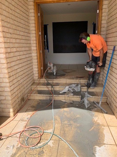 Man Using A Floor Drilling Machine To Cut Stairs — Concrete Cutting Services in Bundaberg, QLD