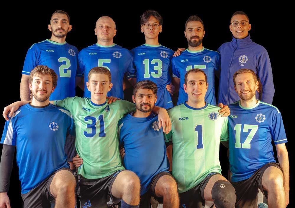 A group of men in blue and green jerseys are posing for a picture.