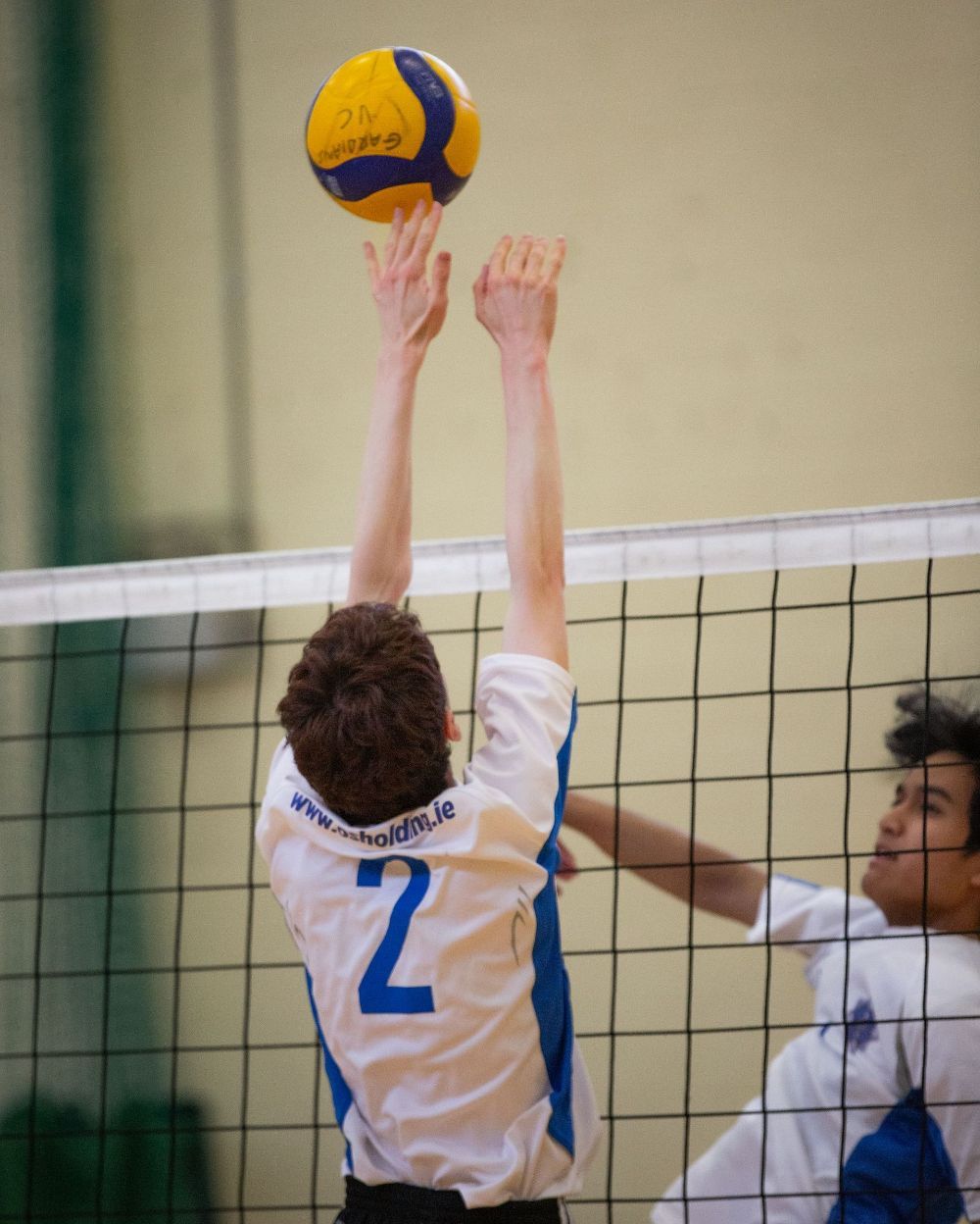 A volleyball player with the number 2 on his jersey