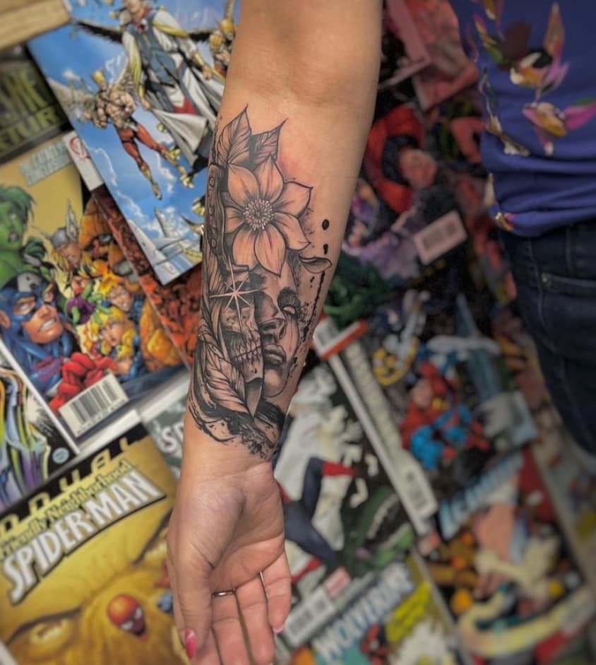 Forearm with floral tattoo against a colorful comic book wall background