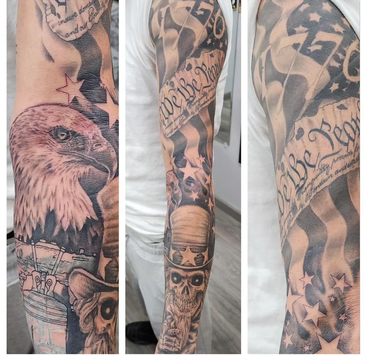 Tattooed arm showing skull, eagle, stars, and script sleeve designs in black and gray