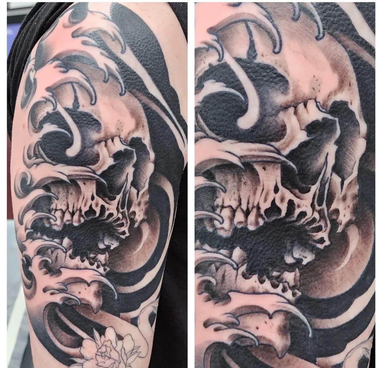 Black and gray skull tattoo on an upper arm with swirling smoke-like shading