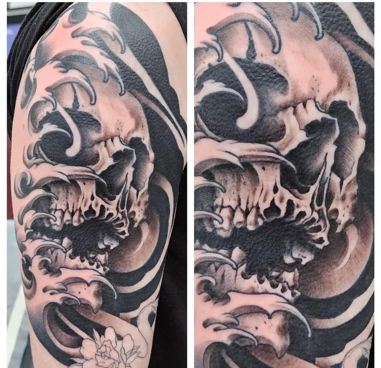 Black cat tattoo with a collar on a person’s upper arm next to blue jeans