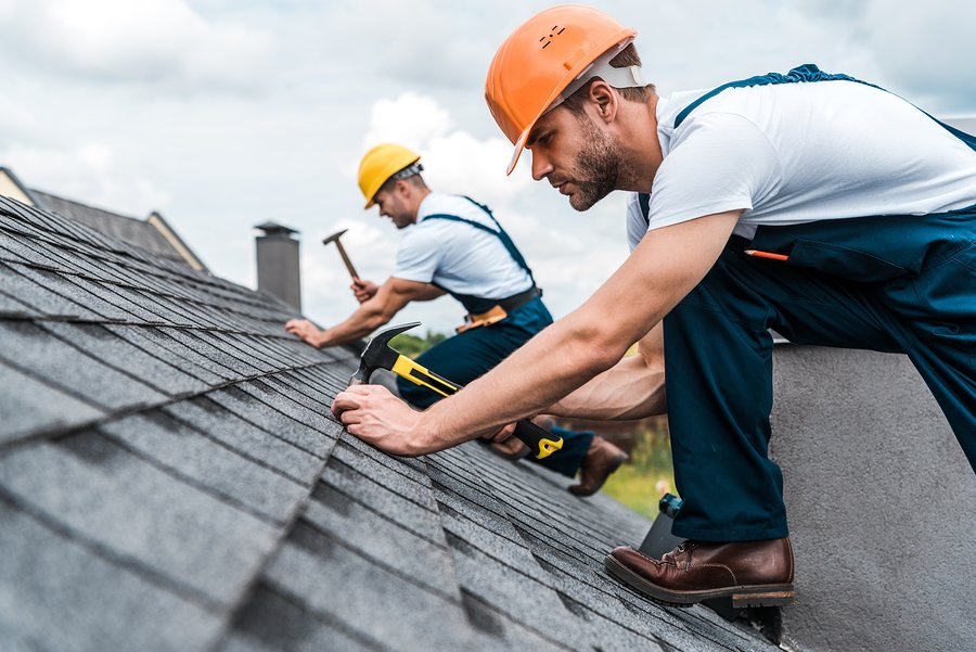 two workers fixing the roof