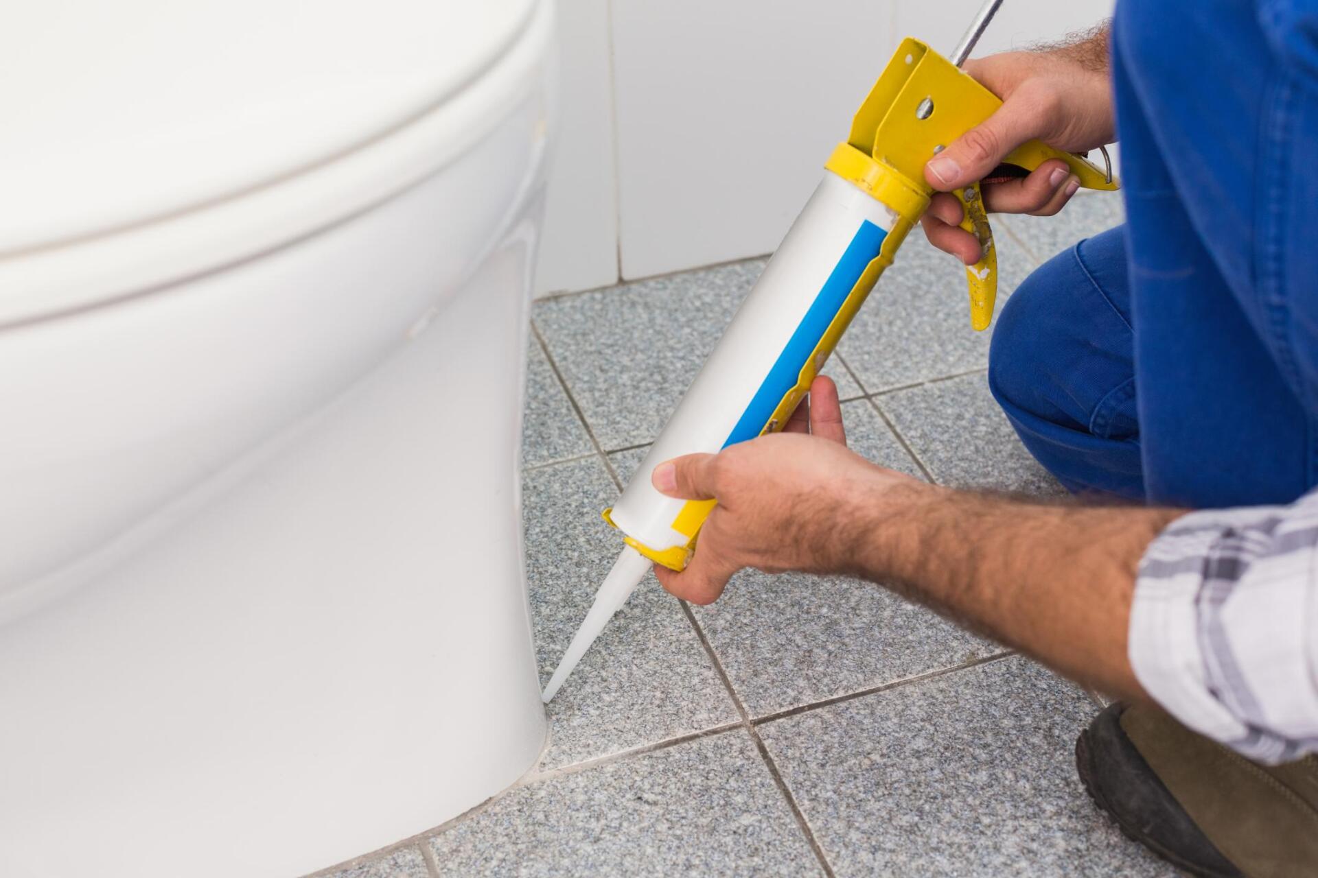 worker using a caulk gun