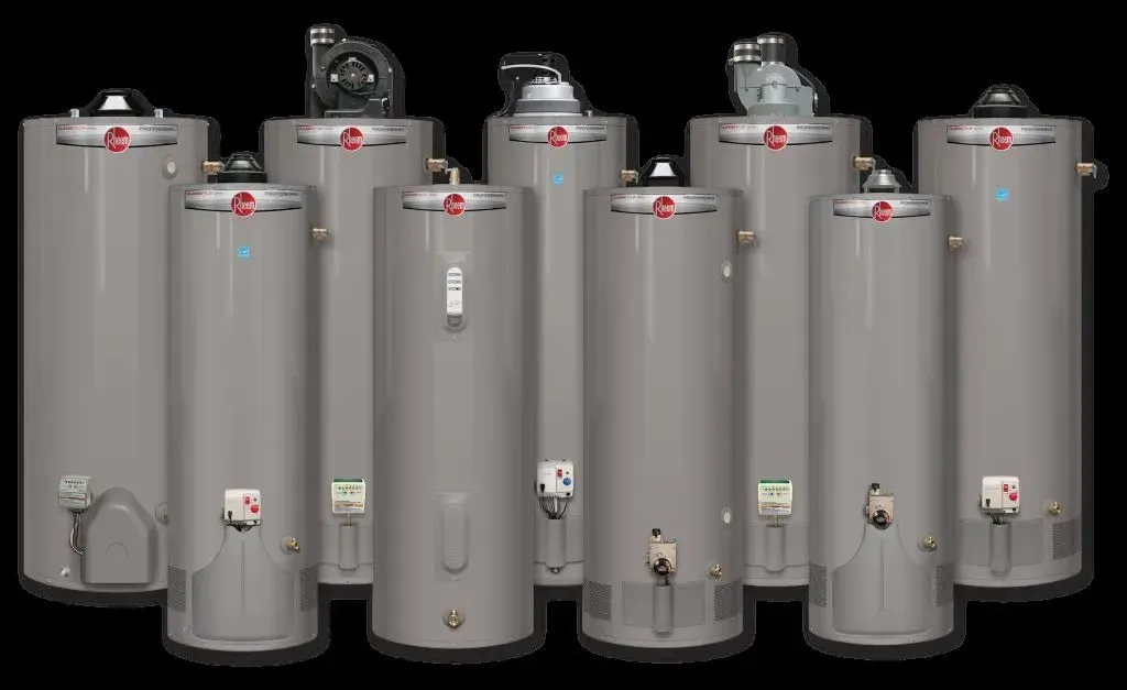 Row of tall gray industrial water heaters/tanks with valves and gauges on top and fronts