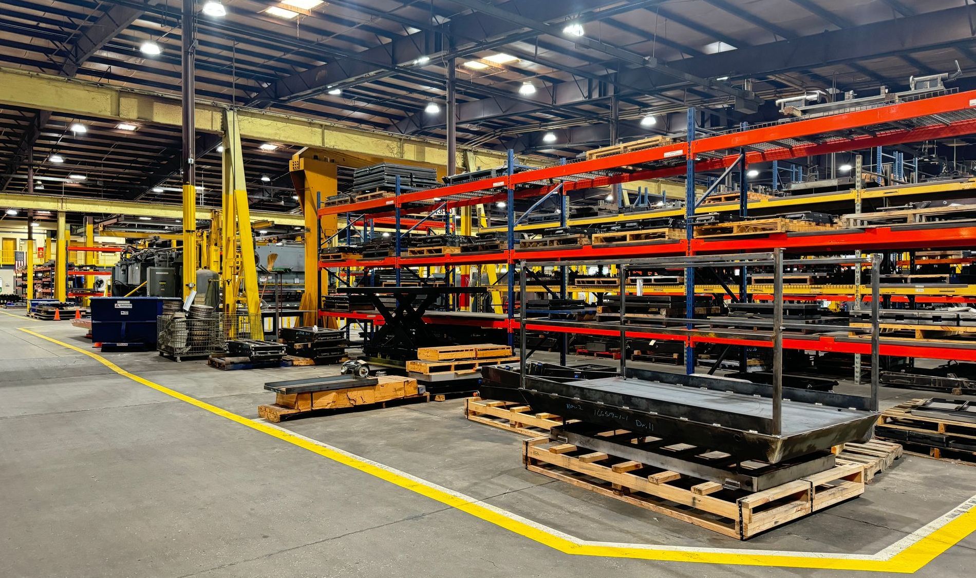 Autoquip's warehouse filled with shelves and pallets.