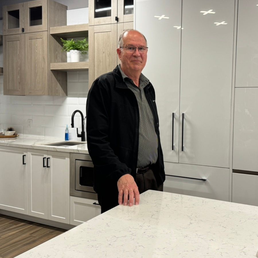 Steve Prentice with Reid Cabinetry stands in front of cabinets in his showroom.