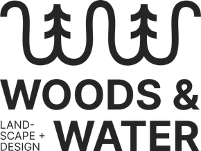 Logo of a brown excavator among green pine trees with &ldquo;WOODS and WATER OUTDOOR LIVING&rdquo; text