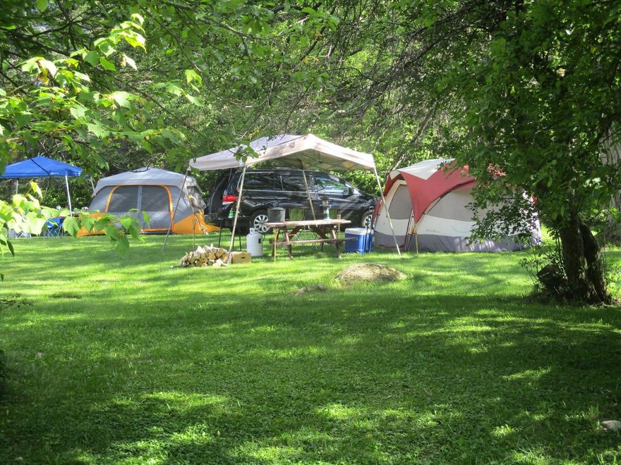 Wooden Apple Hill Campground cabin with a red apple sign on the front.