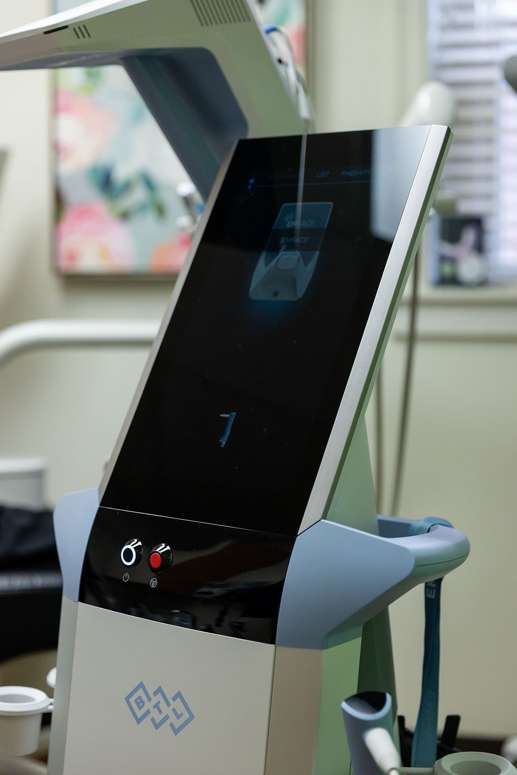 Black medical device with touchscreen and teal side supports