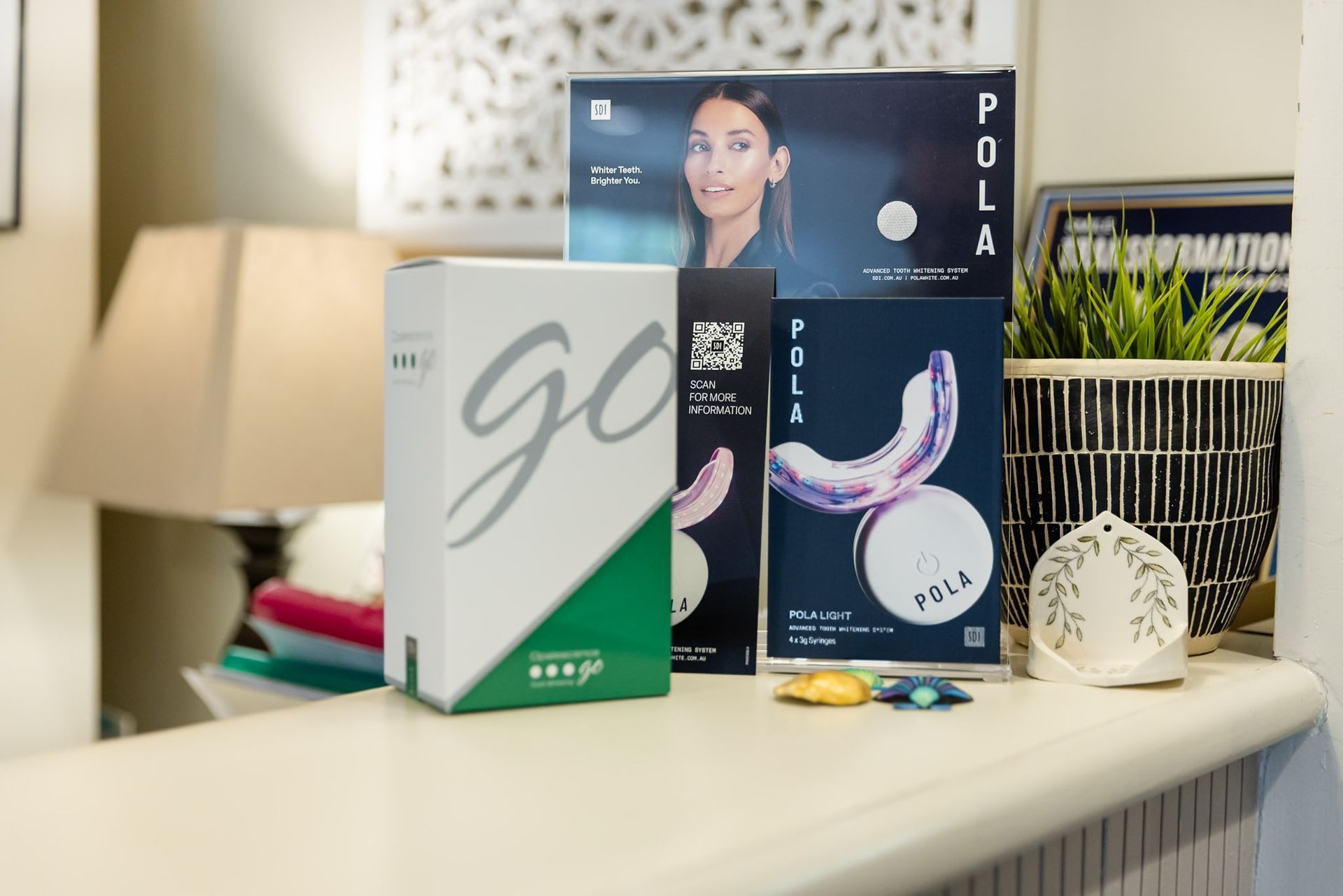 Product display with green and navy boxes on a countertop